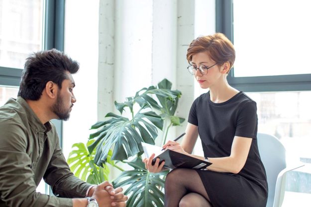 Why is Mental Health Care Important_ man talking with therapist about mental health care